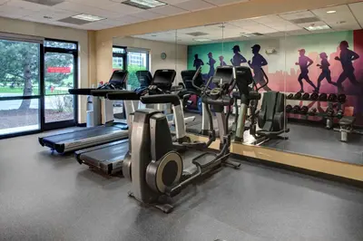 a gym with cardio machines and a wall mural at Candlewood Suites - Cincinnati Northeast - Mason by IHG in Mason