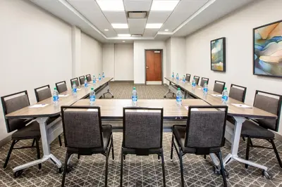 a conference room with a long table and chairs at Candlewood Suites - Cincinnati Northeast - Mason by IHG in Mason
