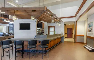 a large kitchen with a bar with stools at Extended Stay America Premier Suites - Cleveland - Independence in Independence