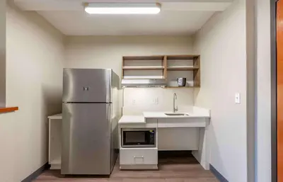 a kitchen with a stainless steel refrigerator and a sink at Extended Stay America Premier Suites - Cleveland - Independence in Independence