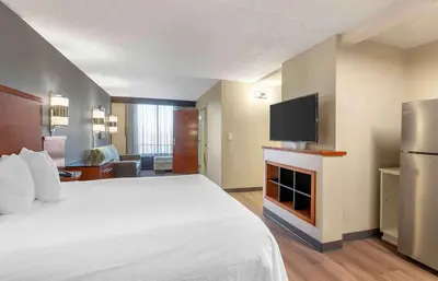 a hotel room with a bed and a flat screen tv at Extended Stay America Premier Suites - Cleveland - Independence in Independence