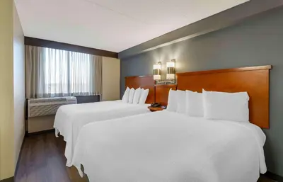 a hotel room with two beds and a window at Extended Stay America Premier Suites - Cleveland - Independence in Independence