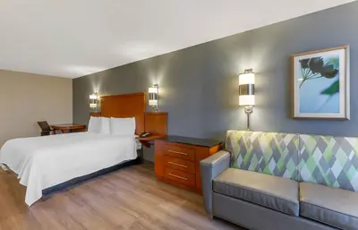 a hotel room with a bed and a couch at Extended Stay America Premier Suites - Cleveland - Independence in Independence