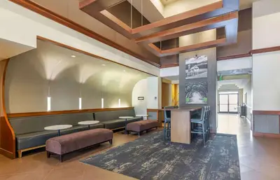 a waiting room with benches and tables in a building at Extended Stay America Premier Suites - Cleveland - Independence in Independence