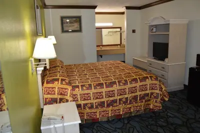 a hotel room with a bed and a television at Economy Inn Cuyahoga Falls in Cuyahoga Falls