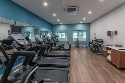 a gym with treadmills and elliptical machines at Holiday Inn Express & Suites - Columbus - Worthington by IHG in Columbus