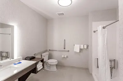 a white bathroom with a toilet and a shower at Holiday Inn Express & Suites - Columbus - Worthington by IHG in Columbus