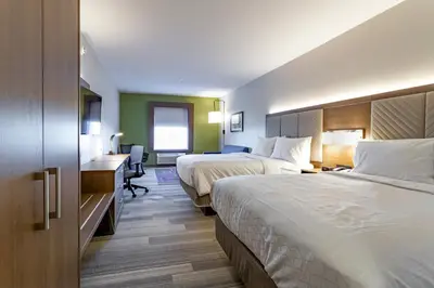 a hotel room with two beds and a desk at Holiday Inn Express & Suites - Columbus - Worthington by IHG in Columbus