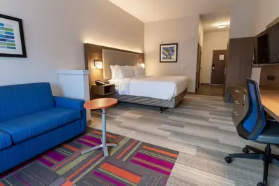 a hotel room with a bed and a couch at Holiday Inn Express & Suites - Columbus - Worthington by IHG in Columbus
