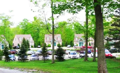a parking lot with cars parked in a yard at Spruce Hill Inn & Cottages in Mansfield