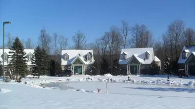 a group of houses covered in snow at Spruce Hill Inn & Cottages in Mansfield