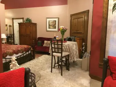 a bedroom with a table and a bed at Spruce Hill Inn & Cottages in Mansfield