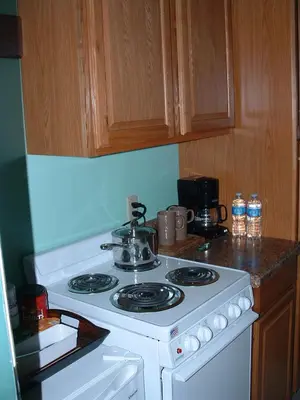 a kitchen with a stove with a tea pot on it at Spruce Hill Inn & Cottages in Mansfield