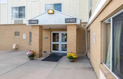 a front door of a building with two potted plants at Extended Stay America Suites - Cincinnati - Blue Ash - Kenwood Road in Blue Ash