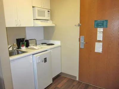 a small kitchen with a sink and a microwave at Extended Stay America Suites - Cincinnati - Blue Ash - Kenwood Road in Blue Ash