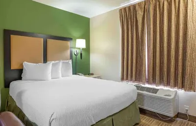 a hotel room with a large bed and a window at Extended Stay America Suites - Cincinnati - Blue Ash - Kenwood Road in Blue Ash
