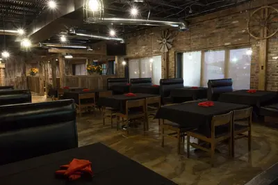 a dining room with black tables and chairs at Days Inn by Wyndham Columbus East Airport in Columbus