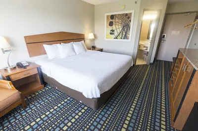a hotel room with a bed and a desk at Days Inn by Wyndham Florence Cincinnati Area in Florence