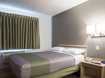 a bed in a small room with a window at Studio 6-Miamisburg, OH - Dayton in Miamisburg