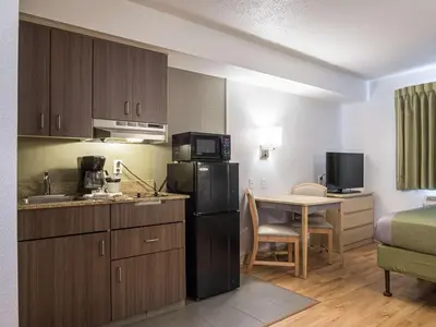 a room with a kitchen and a room with a table at Studio 6-Miamisburg, OH - Dayton in Miamisburg