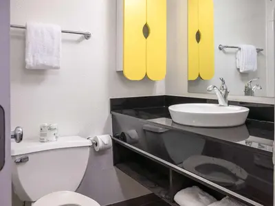 a bathroom with a white toilet and a sink at Studio 6-Miamisburg, OH - Dayton in Miamisburg