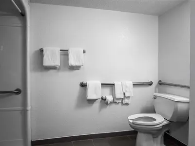 a bathroom with a white toilet and towels at Studio 6-Miamisburg, OH - Dayton in Miamisburg