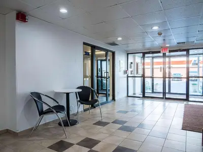 a room with chairs and a table in a building at Studio 6-Miamisburg, OH - Dayton in Miamisburg