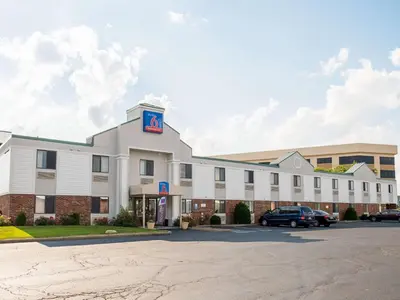 a large white building with a parking lot at Studio 6-Miamisburg, OH - Dayton in Miamisburg
