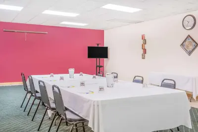 a conference room with a white table and chairs at Days Inn by Wyndham St Clairsville in Saint Clairsville