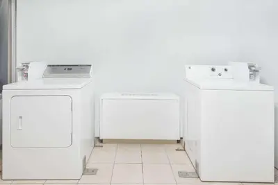 a room with two refrigerators and a washer and dryer at Days Inn by Wyndham St Clairsville in Saint Clairsville