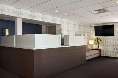 an office with a reception desk with a tv on the wall at Travelodge by Wyndham Hubbard OH in Hubbard