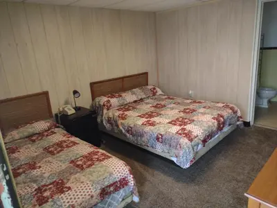 a hotel room with two beds and a toilet at Davis Motel in North Lima