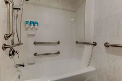 a bathroom with a shower and a tub and a sink at Drury Inn & Suites Columbus Dublin in Dublin