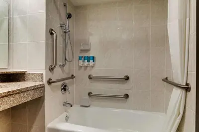a bathroom with a shower and a bath tub at Drury Inn & Suites Columbus Dublin in Dublin