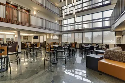 a restaurant with tables and chairs and windows at Drury Inn & Suites Columbus Dublin in Dublin