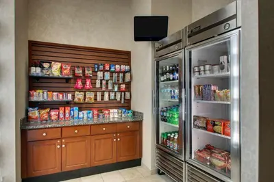 a kitchen with a refrigerator and some food at Drury Inn & Suites Findlay in Findlay