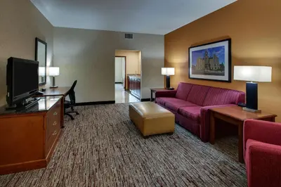 a hotel room with a couch and a tv at Drury Inn & Suites Findlay in Findlay