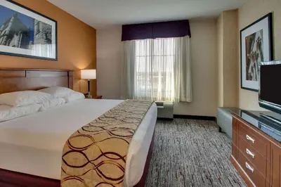 a hotel room with a large bed and a television at Drury Inn & Suites Findlay in Findlay