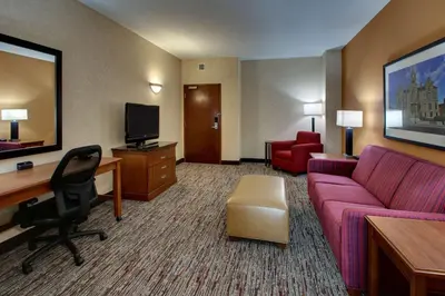 a hotel room with a couch and a desk at Drury Inn & Suites Findlay in Findlay