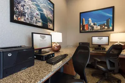 an office with a computer and a desk with two monitors at Drury Inn & Suites Cincinnati Sharonville in Sharonville