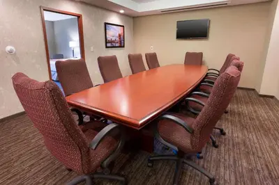a conference room with a wooden table and chairs at Drury Inn & Suites Cincinnati Sharonville in Sharonville