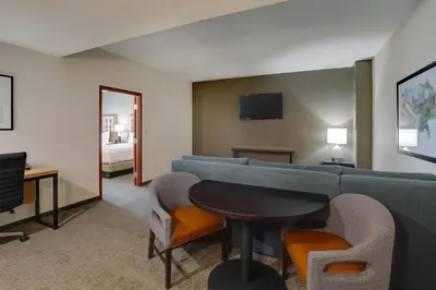 a living room with a couch and a table at Drury Inn & Suites Dayton North in Dayton
