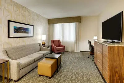 a living room with a couch and a flat screen tv at Drury Plaza Hotel Columbus Downtown in Columbus