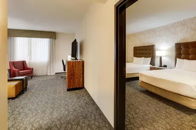 a hotel room with a bed and a mirror at Drury Plaza Hotel Columbus Downtown in Columbus