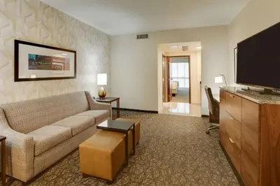 a living room with a couch and a flat screen tv at Drury Plaza Hotel Columbus Downtown in Columbus