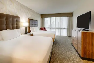 a hotel room with two beds and a flat screen tv at Drury Plaza Hotel Columbus Downtown in Columbus