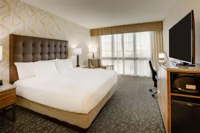 a hotel room with a large bed and a flat screen tv at Drury Plaza Hotel Columbus Downtown in Columbus