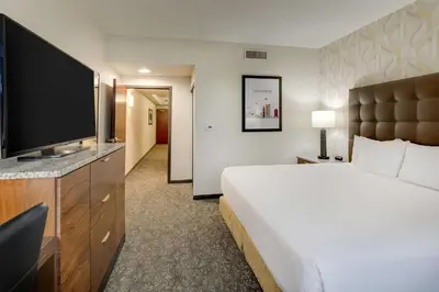 a hotel room with a large bed and a flat screen tv at Drury Plaza Hotel Columbus Downtown in Columbus
