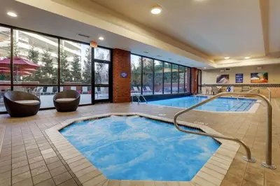a pool in a hotel room with chairs and a swimming pool at Drury Plaza Hotel Columbus Downtown in Columbus
