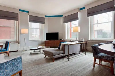 a living room filled with furniture and a flat screen tv at The Westin Great Southern Columbus in Columbus
